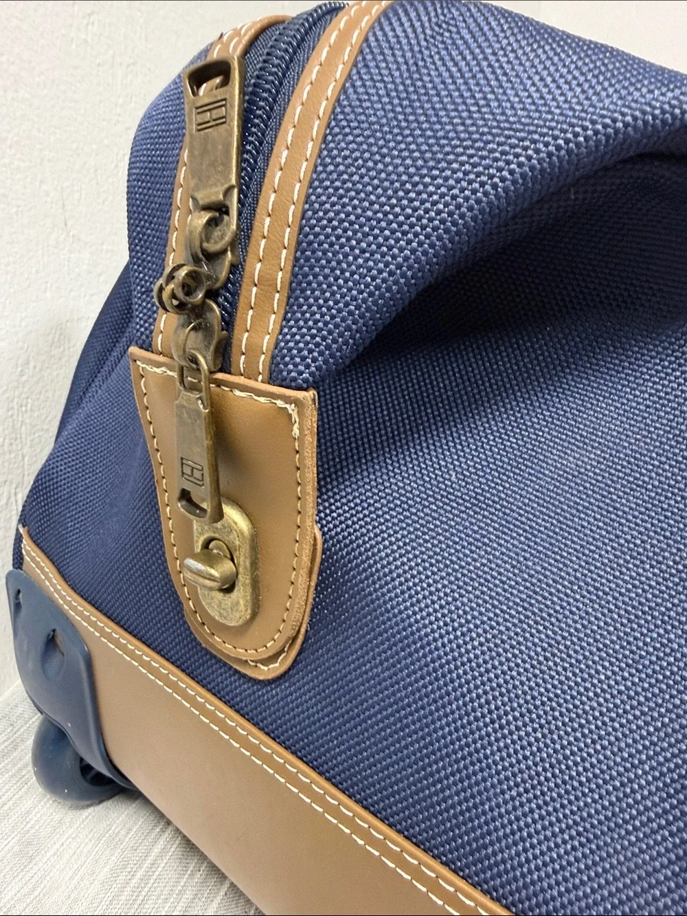 Tommy Hilfiger Navy rolling Duffel with Red & White Center Stripe  carry on